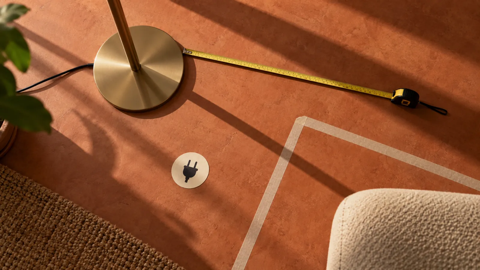 Lamp base, measuring tape and socket marker on terracotta