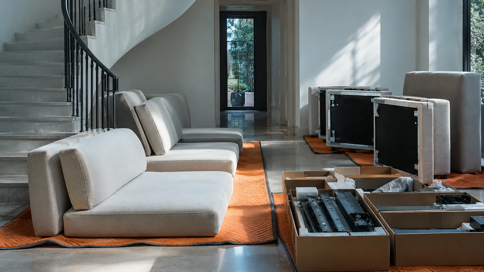 Separated sofa sections staged beside a curved delivery route